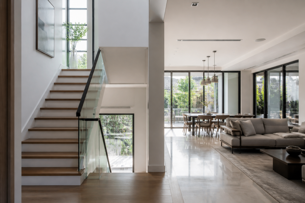 Semi-detached house staircase and living area with natural daylight from side windows
